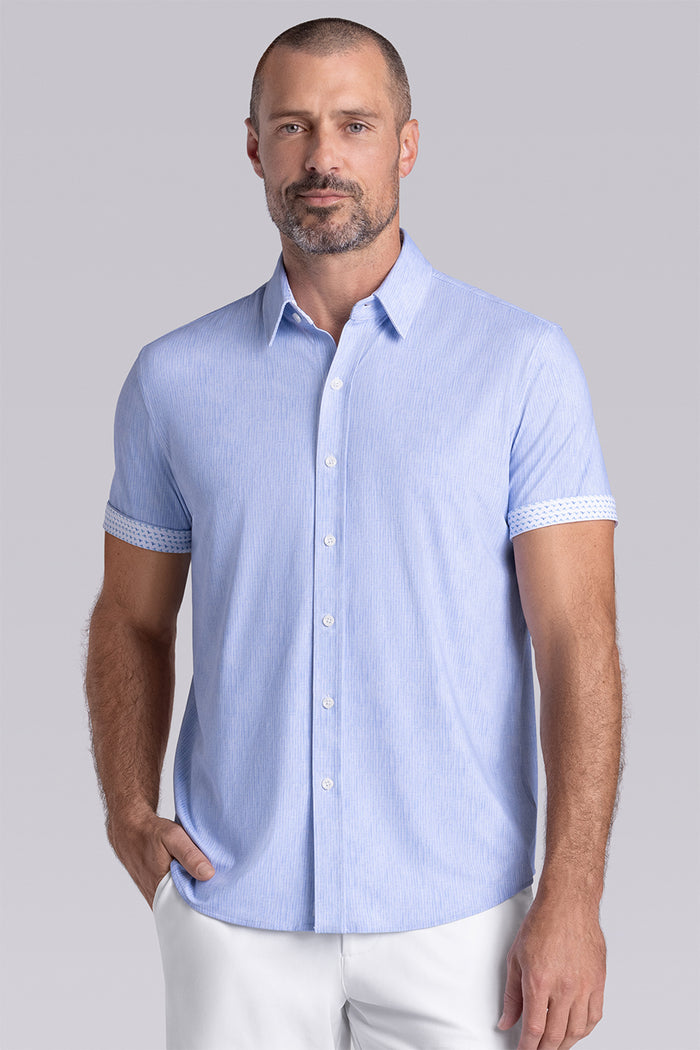 Model wearing Ocean Drive Icy Blue short sleeve button-up shirt, styled with white shorts