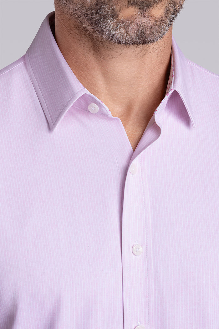 Model wearing Ocean Drive Light Pink short sleeve button-up shirt, styled with navy shorts