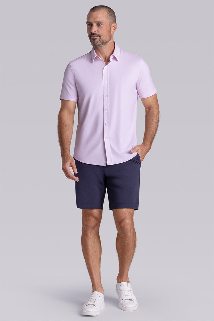 Model wearing Ocean Drive Light Pink short sleeve button-up shirt, styled with navy shorts