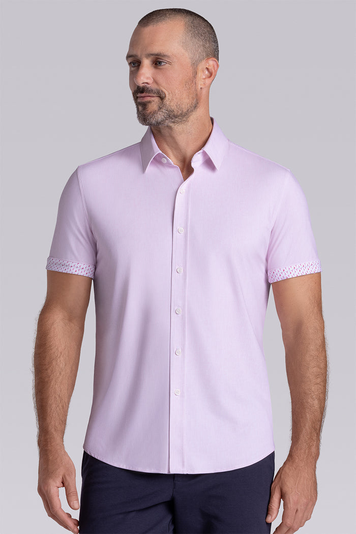 Model wearing Ocean Drive Light Pink short sleeve button-up shirt, styled with navy shorts