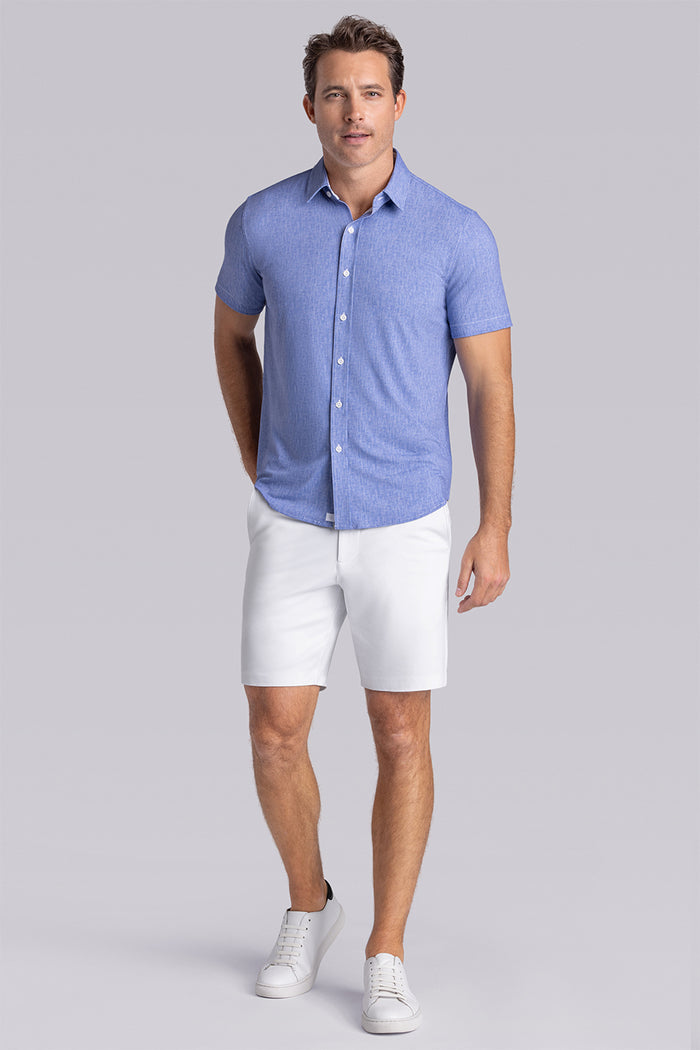 Model wearing Ocean Drive Palace Blue short sleeve button-up shirt, styled with white shorts