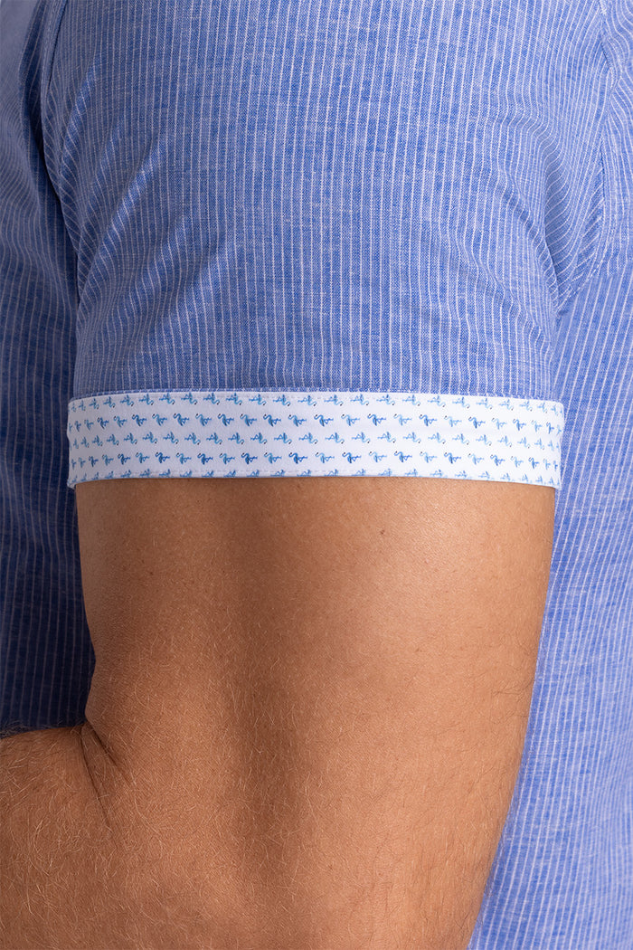 Model wearing Ocean Drive Palace Blue short sleeve button-up shirt, styled with white shorts
