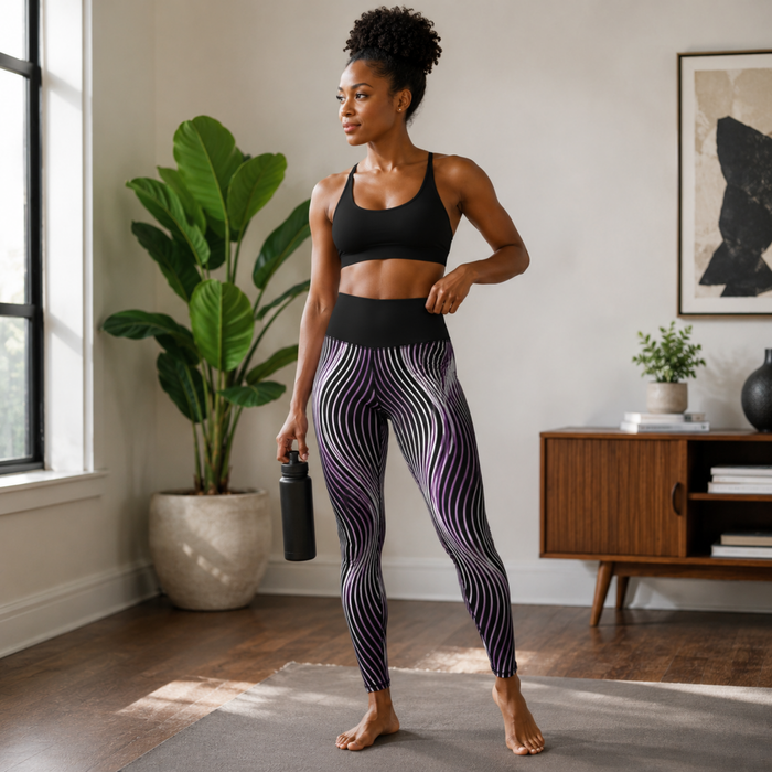 Woman standing in a living room wearing high-waisted Orot OR ARGAMAN royal light purple wave pattern leggings.