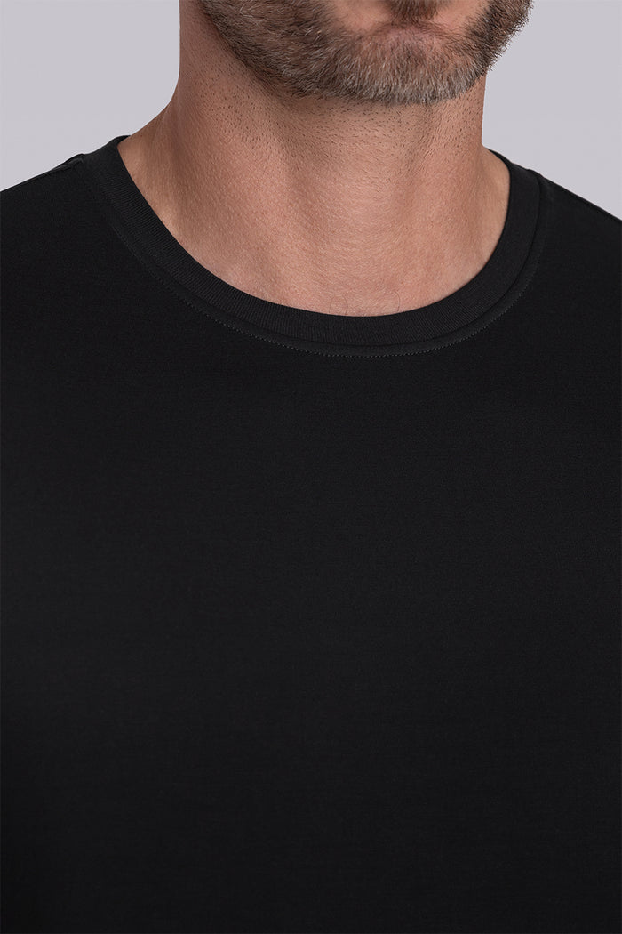 Model wearing Paramount Black long sleeve Icy Bamboo® crewneck, styled with black pants.