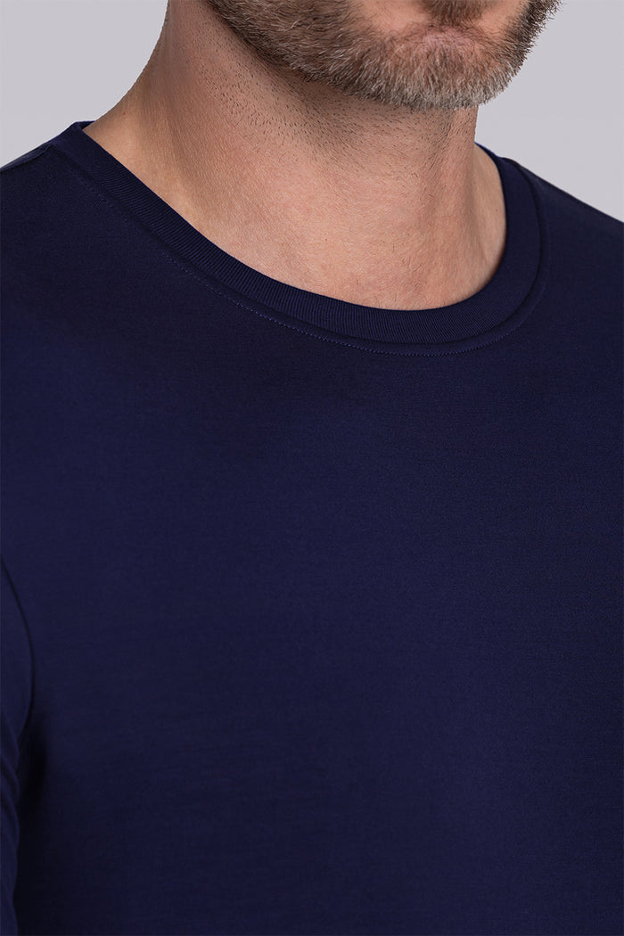 Model wearing Paramount Navy long sleeve Icy Bamboo® crewneck, styled with grey pants.