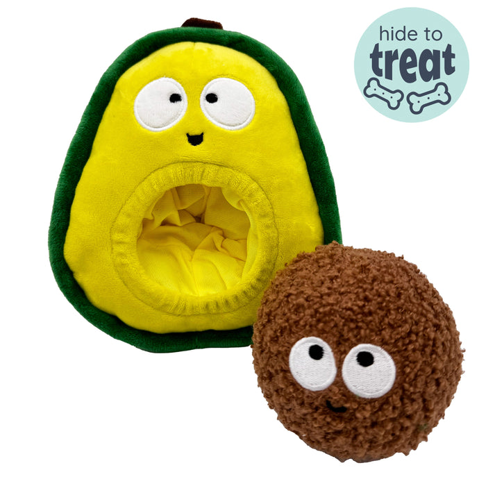 Dog with Pop 'n Fetch Avocado Dog Toy on a white background.