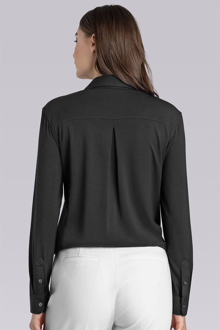 Model wearing Prestige Black long sleeve Icy Bamboo® v-neck shirt, styled with white pants
