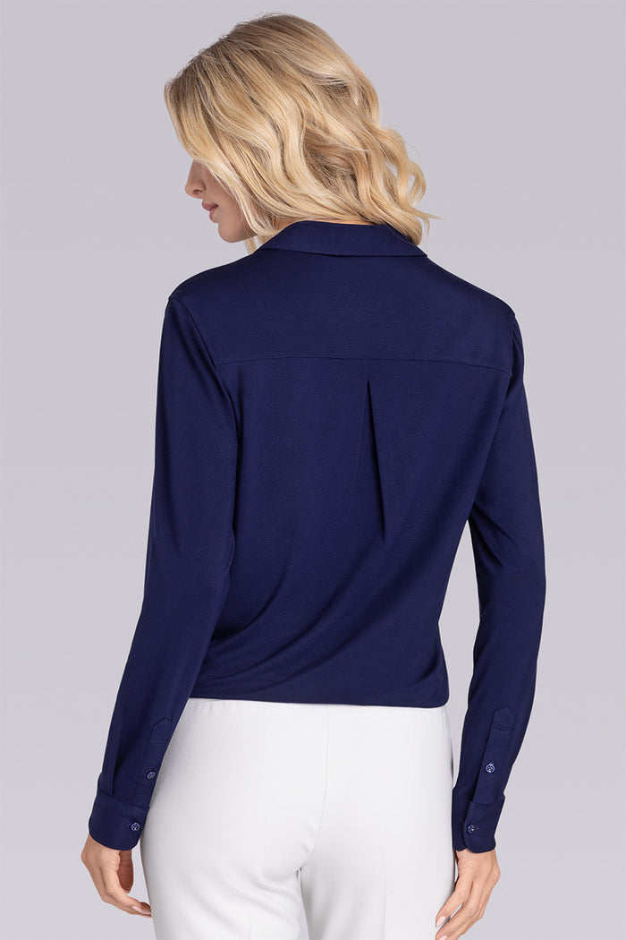 Model wearing Prestige Deep Sea Blue long sleeve Icy Bamboo® v-neck shirt, styled with white pants