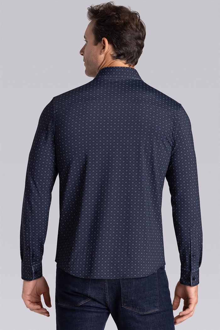 Model wearing Prism Black 6-Way Knit® long sleeve classic collar shirt, styled with black pants