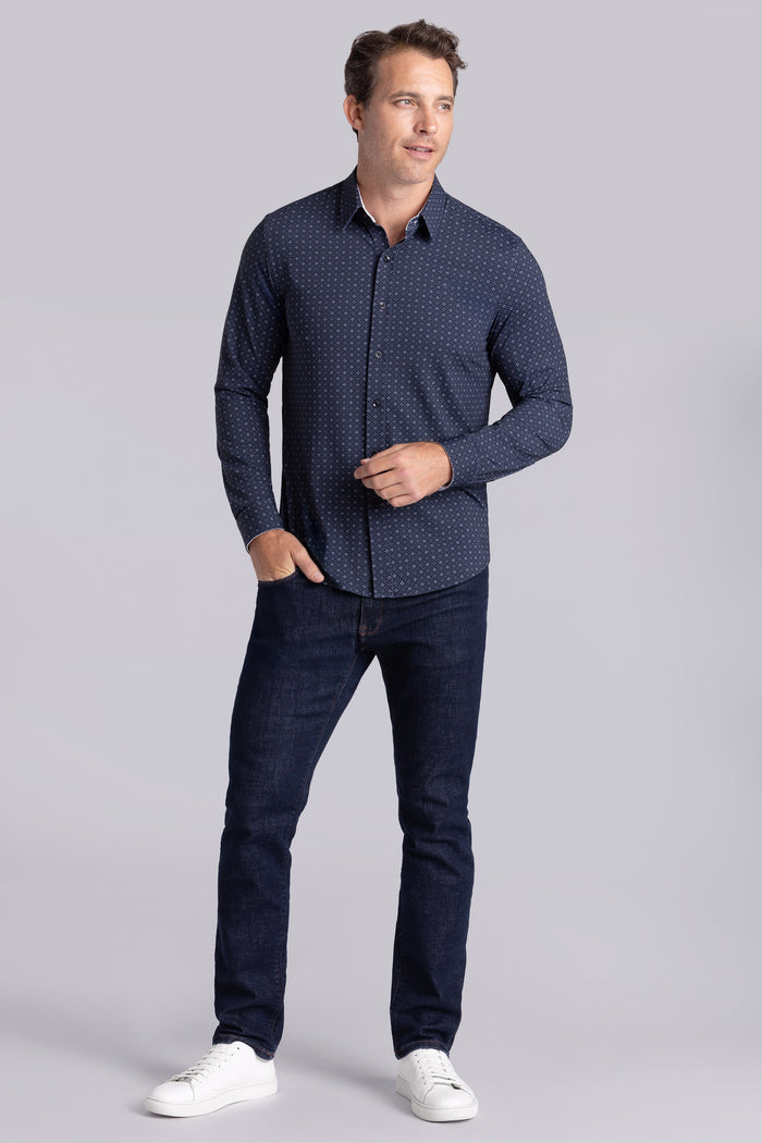 Model wearing Prism Black 6-Way Knit® long sleeve classic collar shirt, styled with black pants