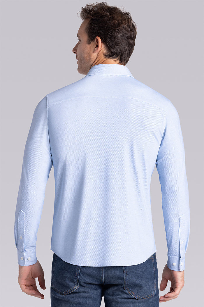 Model wearing Prism Seafoam 6-Way Knit® long sleeve classic collar shirt, styled with jeans