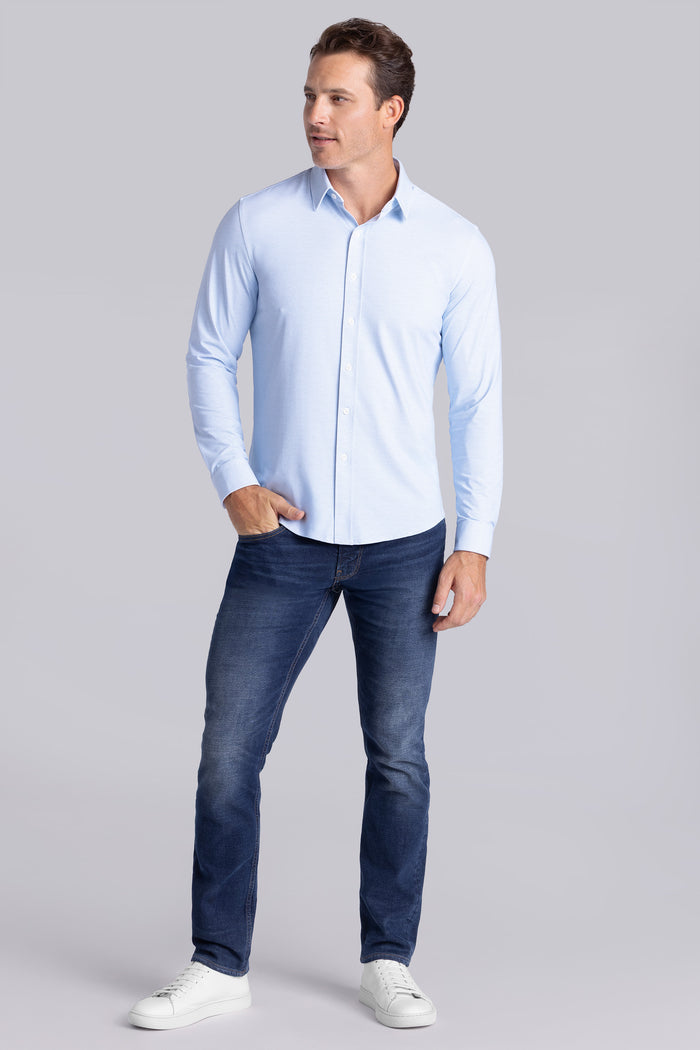 Model wearing Prism Seafoam 6-Way Knit® long sleeve classic collar shirt, styled with jeans