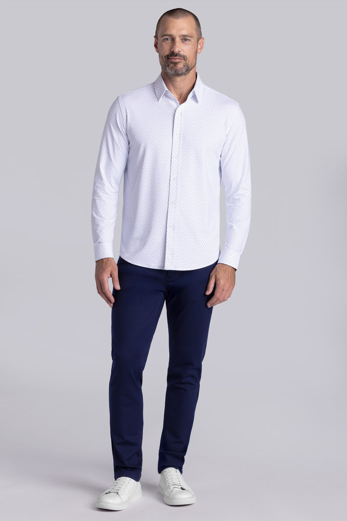 Model wearing Prism White 6-Way Knit® long sleeve classic collar shirt, styled with black pants