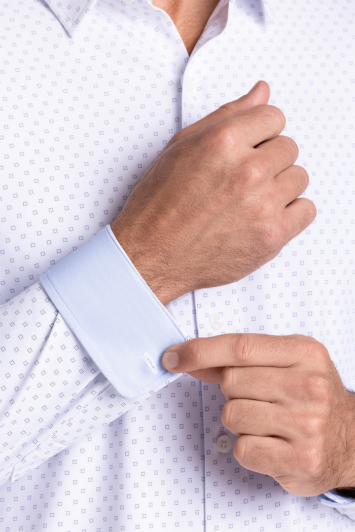 Model wearing Prism White 6-Way Knit® long sleeve classic collar shirt, styled with black pants