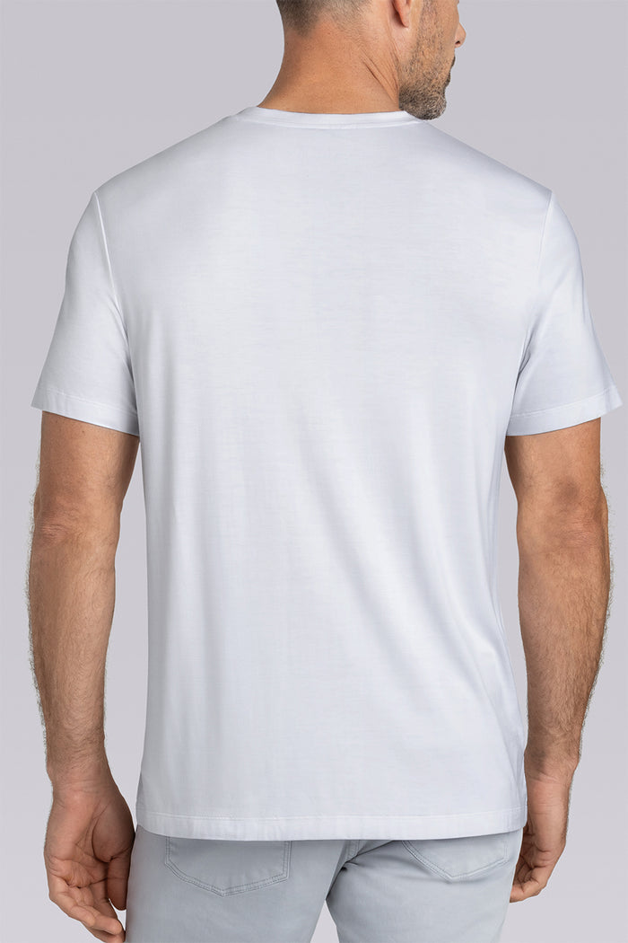 Model wearing Quintessential White short sleeve v-neck shirt, styled with grey pants