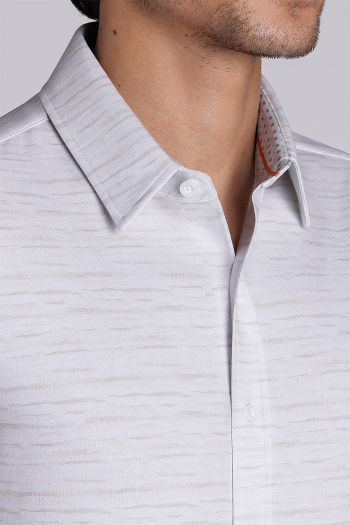Model wearing Radar Beige short sleeve casual shirt with collar, styled with navy pants.