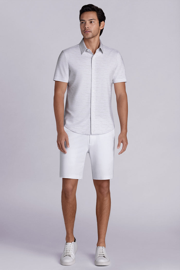 Model wearing Radar Beige short sleeve casual shirt with collar, styled with navy pants.