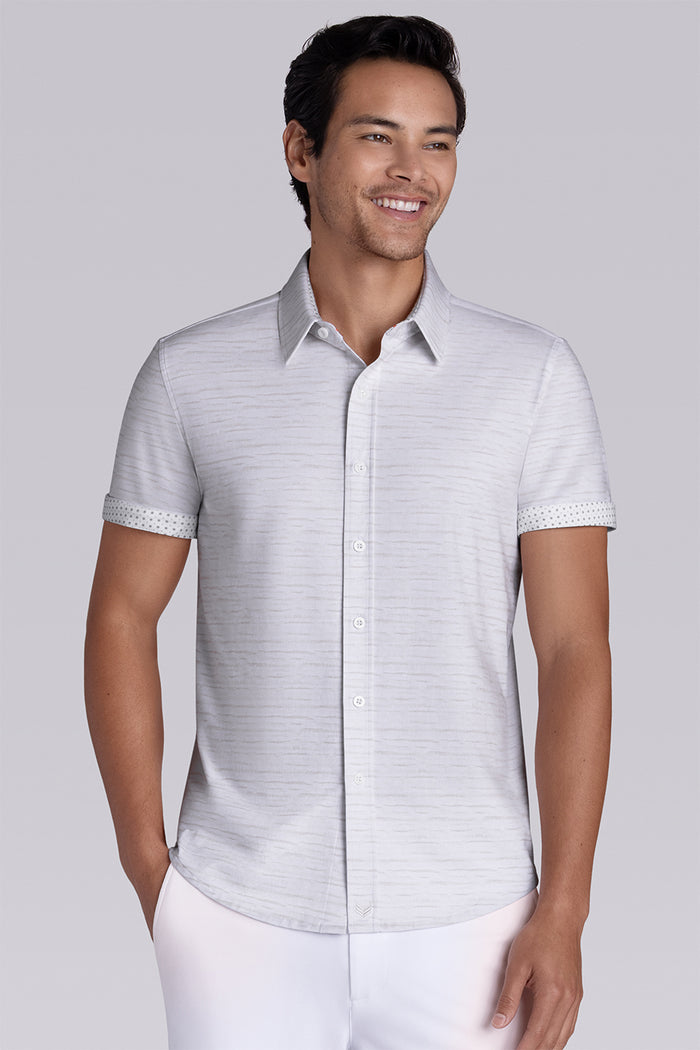 Model wearing Radar Beige short sleeve casual shirt with collar, styled with navy pants.