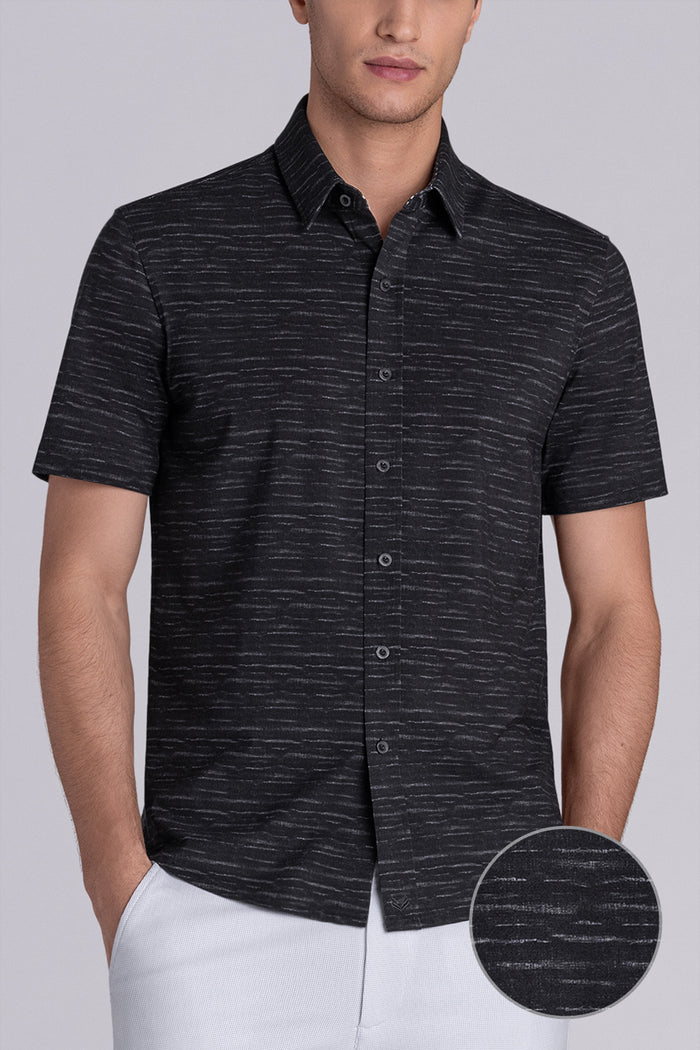 Model wearing Radar Black short sleeve casual shirt with collar, styled with navy pants.