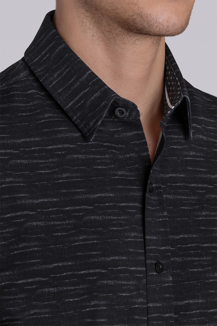 Model wearing Radar Black short sleeve casual shirt with collar, styled with navy pants.