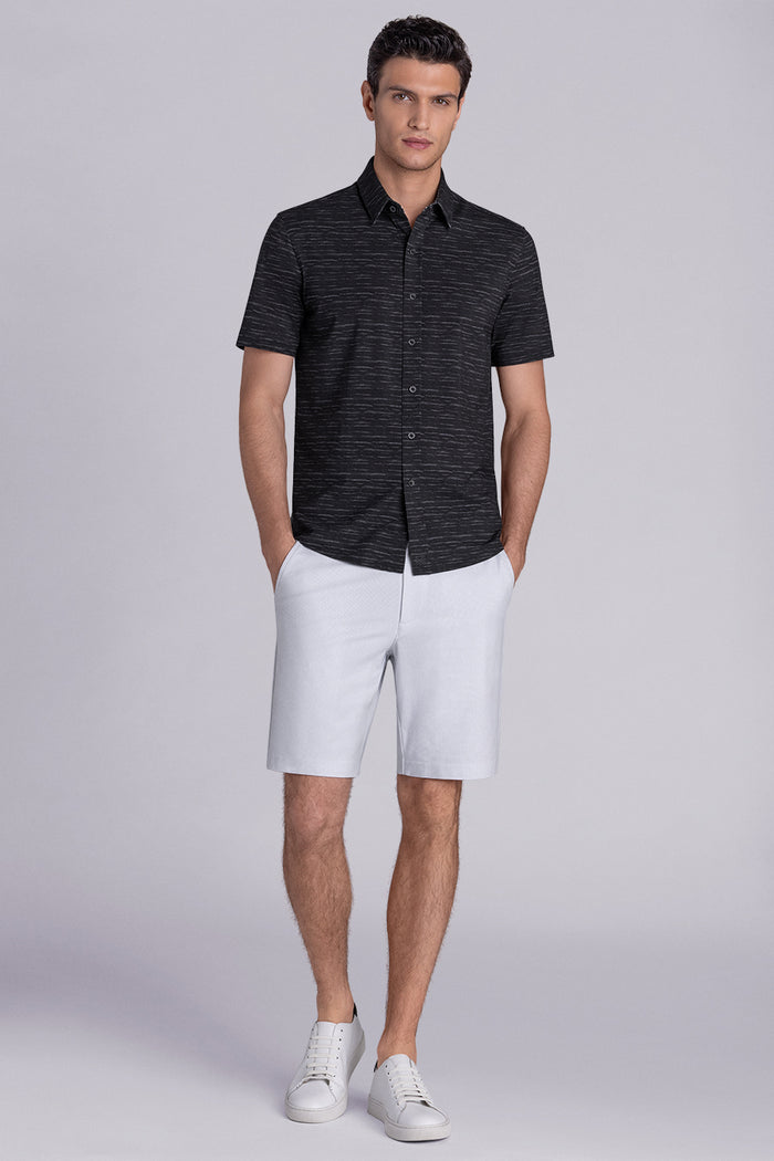 Model wearing Radar Black short sleeve casual shirt with collar, styled with navy pants.