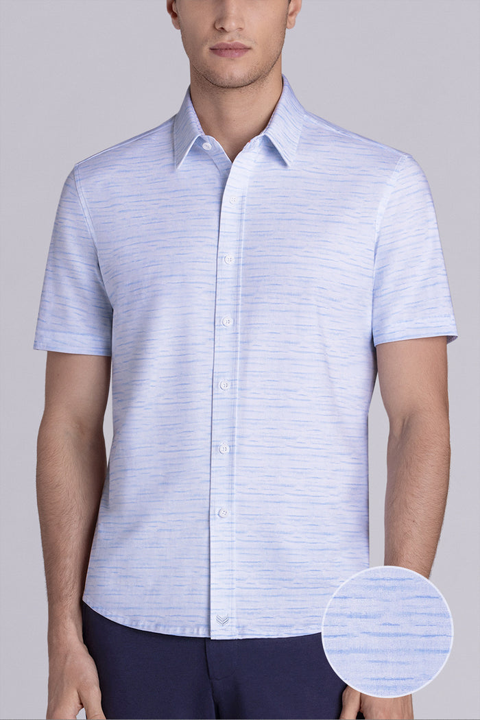Model wearing Radar Light Blue short sleeve casual shirt with collar, styled with navy pants.