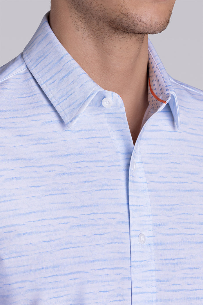 Model wearing Radar Light Blue short sleeve casual shirt with collar, styled with navy pants.
