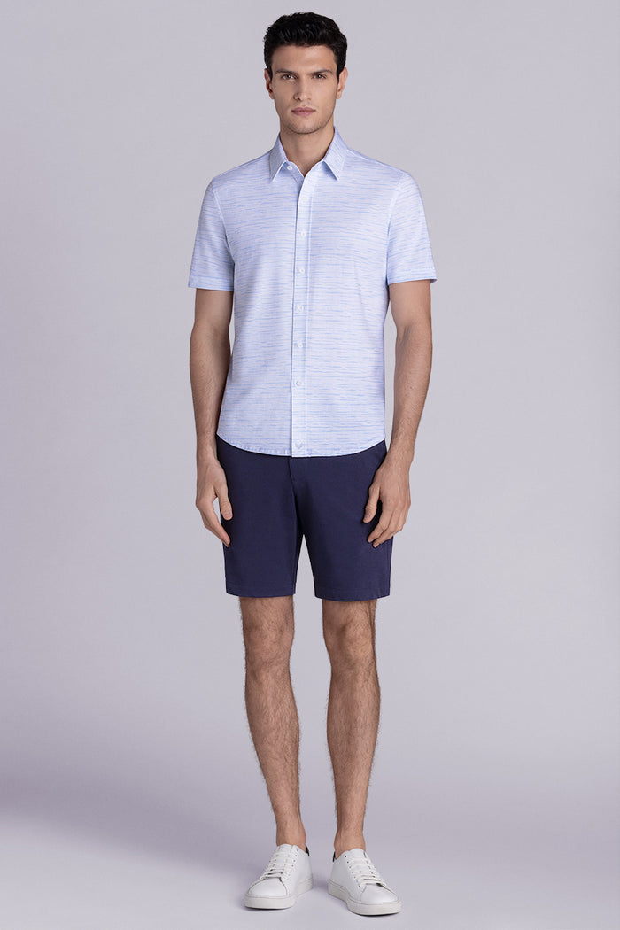 Model wearing Radar Light Blue short sleeve casual shirt with collar, styled with navy pants.