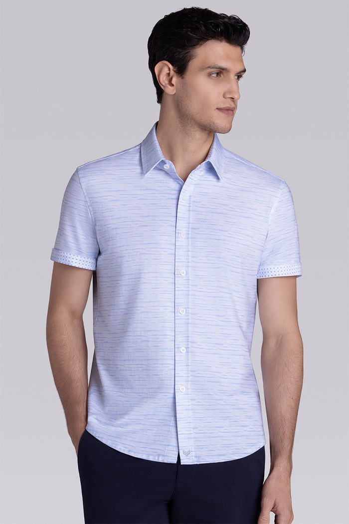 Model wearing Radar Light Blue short sleeve casual shirt with collar, styled with navy pants.