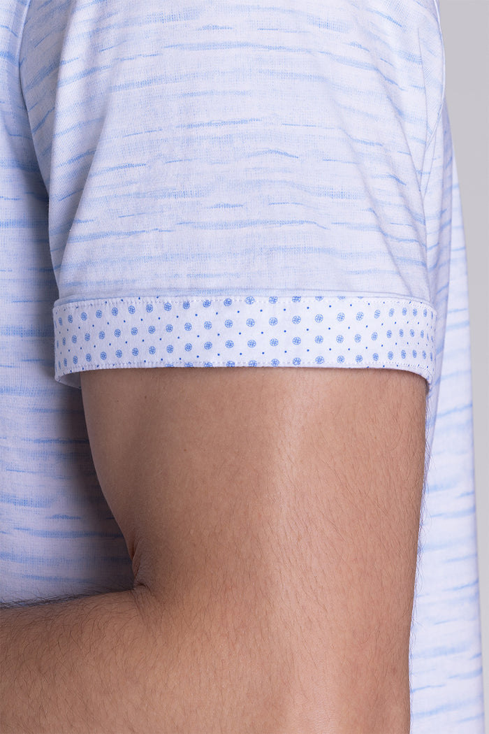 Model wearing Radar Light Blue short sleeve casual shirt with collar, styled with navy pants.