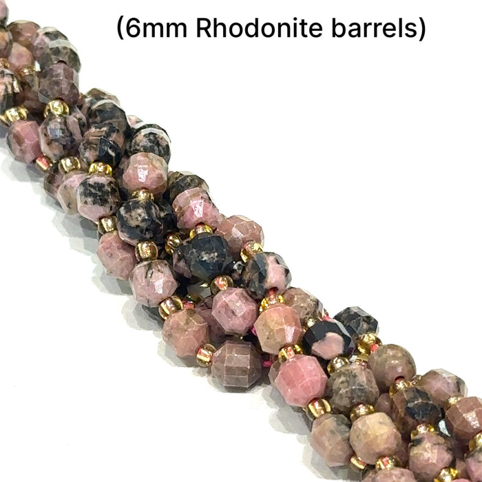 6mm Rhodonite faceted barrels gemstone strands, front overview.
