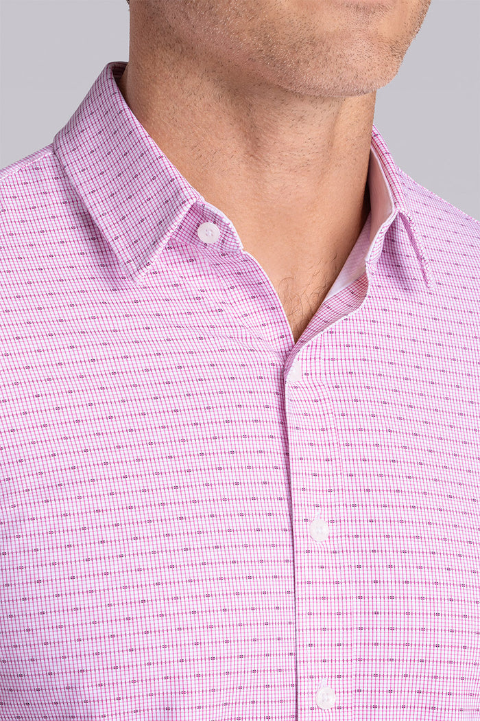 Model wearing Rhythm Raspberry Sorbet 6-Way Knit® short sleeve casual shirt with collar placket, styled with navy shorts.