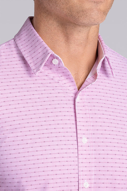 Model wearing Rhythm Raspberry Sorbet 6-Way Knit® short sleeve casual shirt with collar placket, styled with navy shorts.