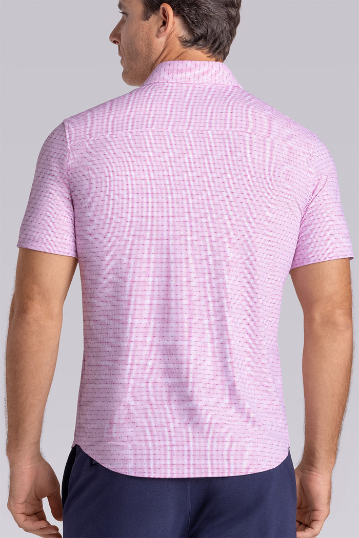 Model wearing Rhythm Raspberry Sorbet 6-Way Knit® short sleeve casual shirt with collar placket, styled with navy shorts.