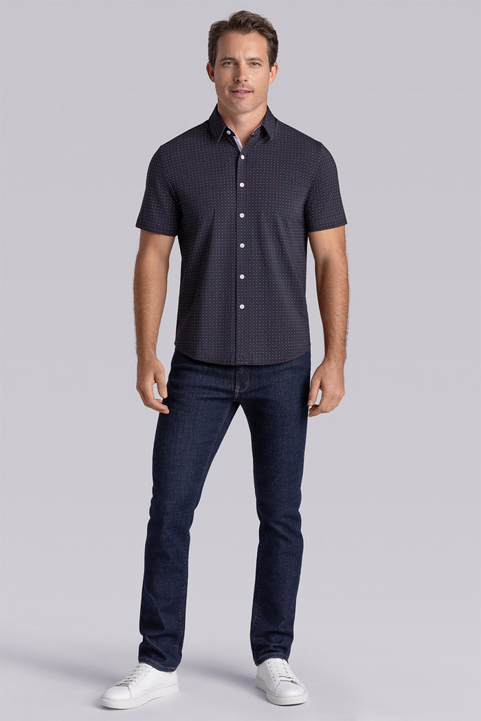 Model wearing Spark Black Icy Cotton® short sleeve classic collar shirt, styled with black pants