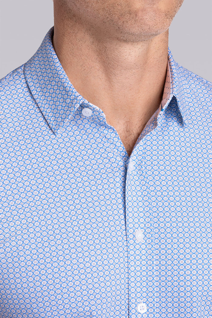 Model wearing Spectrum Light Blue Icy Cotton® short sleeve classic collar shirt, styled with white shorts