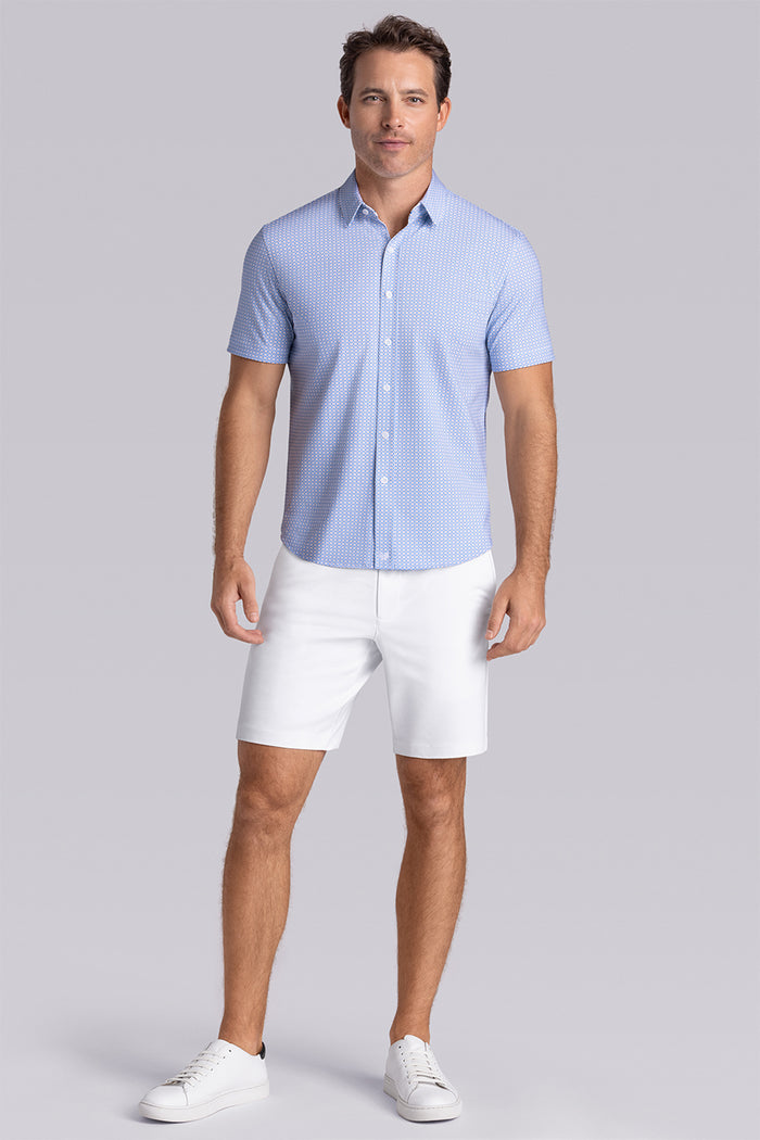 Model wearing Spectrum Light Blue Icy Cotton® short sleeve classic collar shirt, styled with white shorts