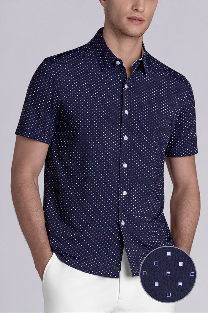 Model wearing Spirited Dark Navy short sleeve classic collar shirt, styled with white shorts