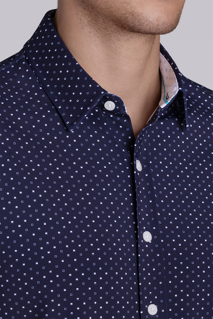Model wearing Spirited Dark Navy short sleeve classic collar shirt, styled with white shorts