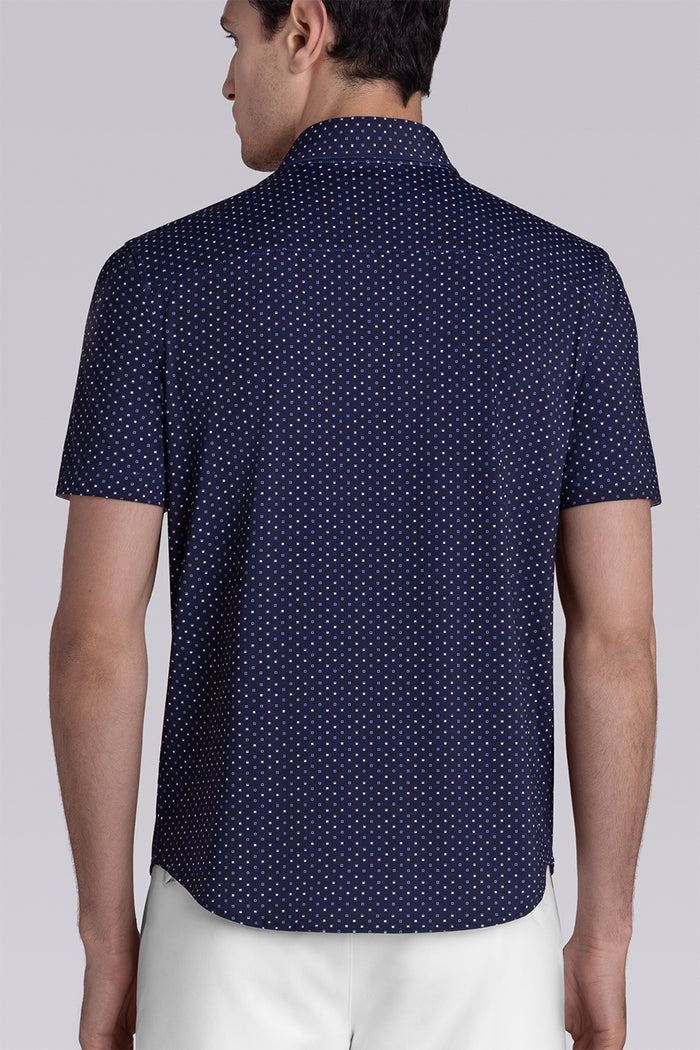 Model wearing Spirited Dark Navy short sleeve classic collar shirt, styled with white shorts