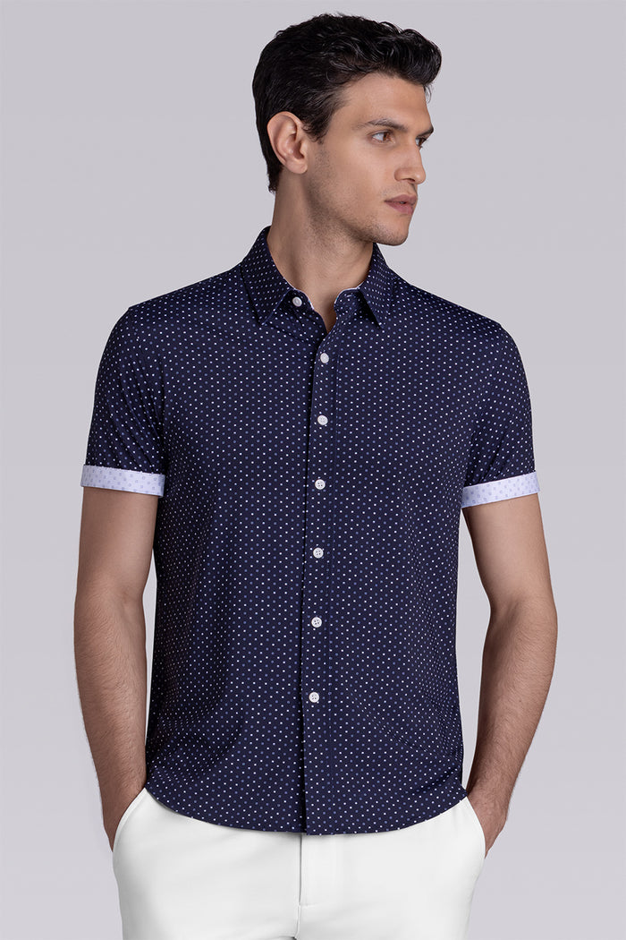 Model wearing Spirited Dark Navy short sleeve classic collar shirt, styled with white shorts