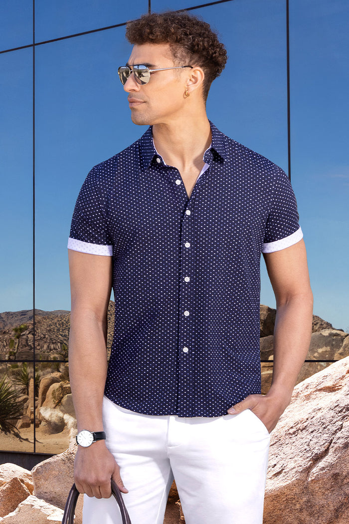 Model wearing Spirited Dark Navy short sleeve classic collar shirt, styled with white shorts