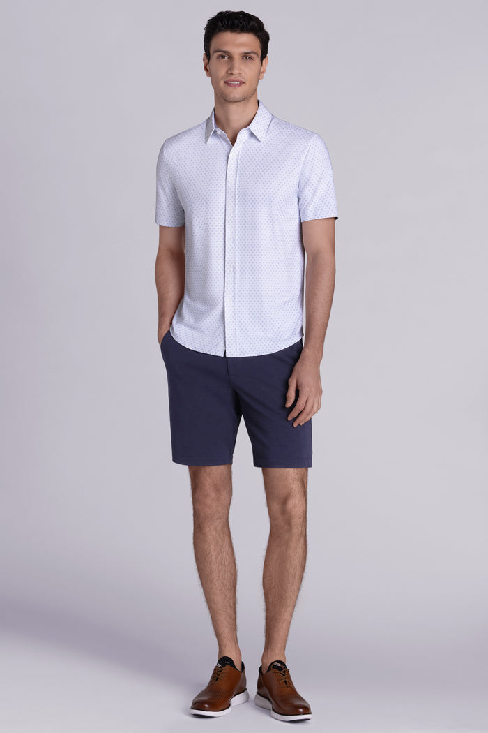 Model wearing Spirited White short sleeve classic collar shirt, styled with navy shorts