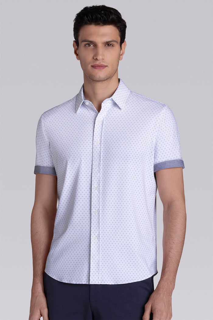 Model wearing Spirited White short sleeve classic collar shirt, styled with navy shorts