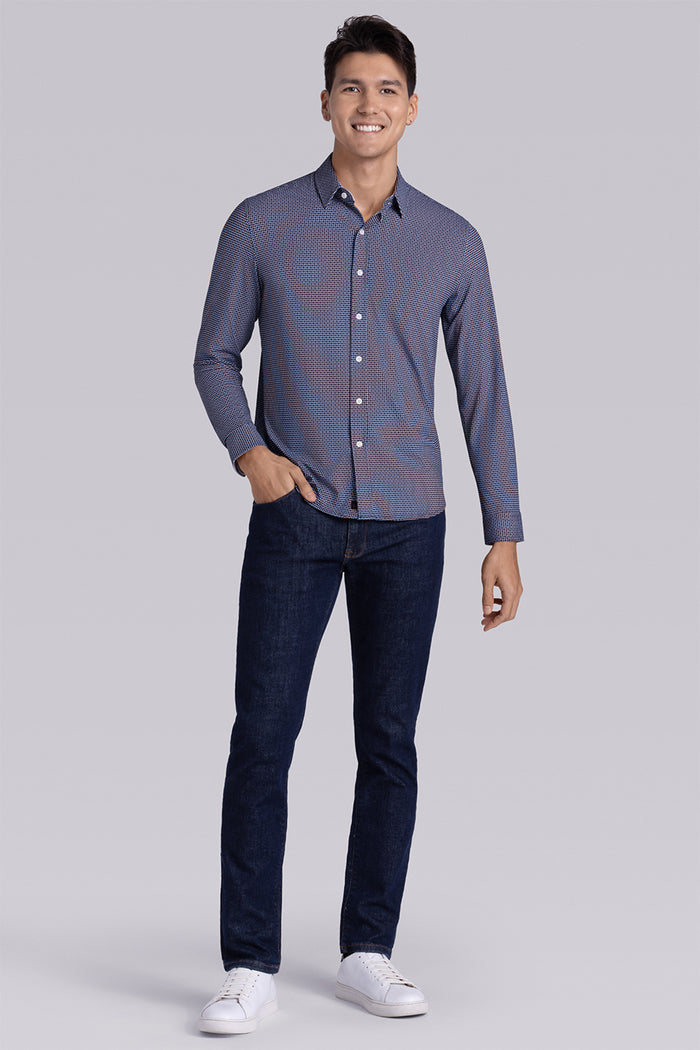 Model wearing Spry Navy Taupe long sleeve shirt with built in classic collar with geometric print, styled with jeans pants.