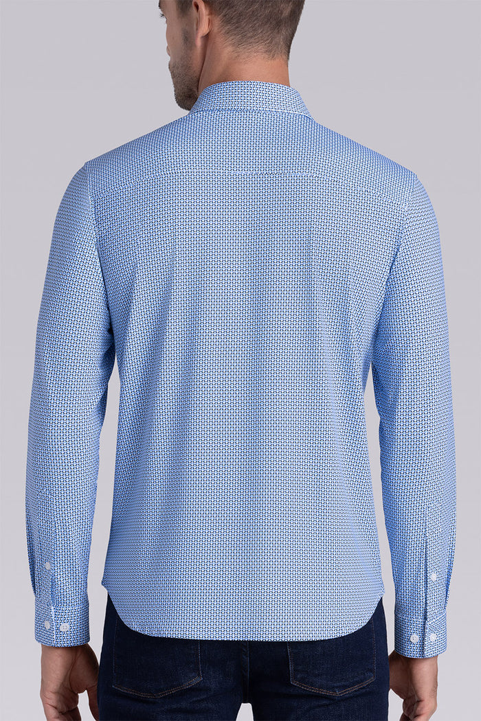 Model wearing Spry Ocean Blue long sleeve shirt with built in classic collar with geometric print, styled with jeans pants.