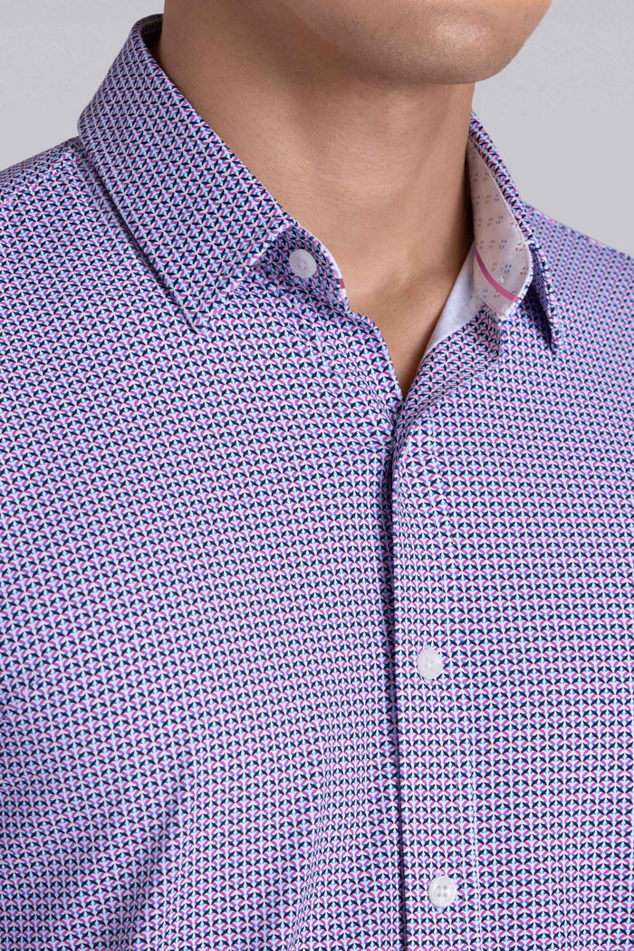 Model wearing Spry Pink long sleeve shirt with built in classic collar with geometric print, styled with jeans pants.
