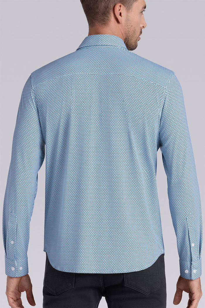 Model wearing Spry Seafoam long sleeve shirt with built in classic collar with geometric print, styled with jeans pants.