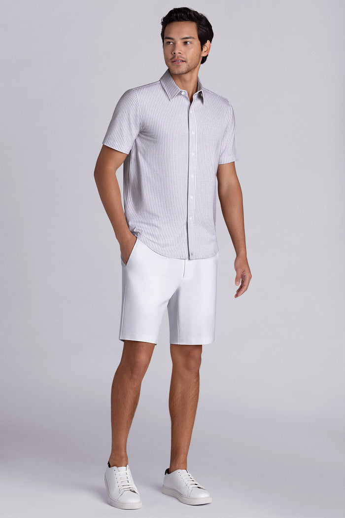 Model wearing Stamina Chateau Grey short sleeve classic collar, styled with white shorts