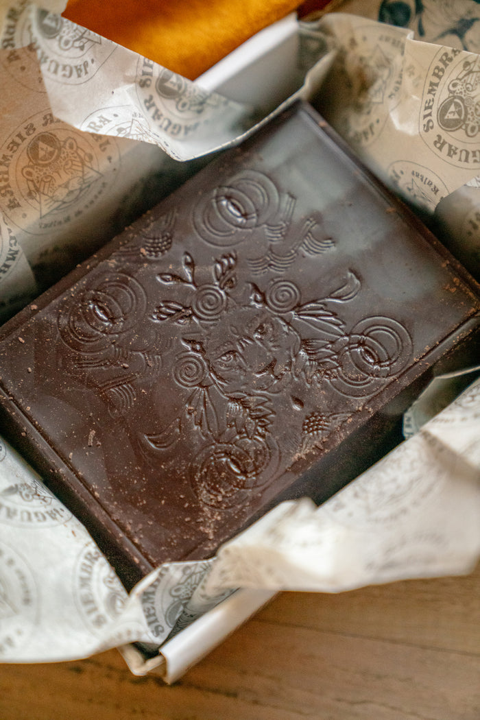 Brown leather wallet with embossed design on patterned fabric
